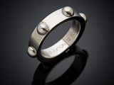a close up of a silver ring on a black surface