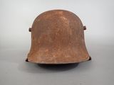 an old helmet is sitting on a table with a white background