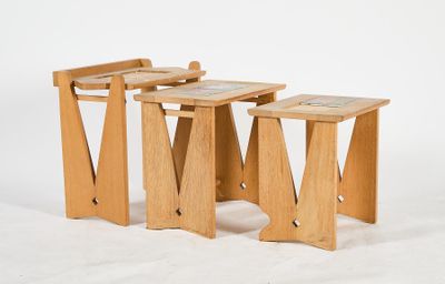 three wooden stools sitting next to each other on a white surface