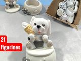 a white bear figurine sitting on a table next to a box of cupcakes