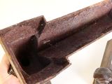 a person holding a piece of rusted metal in their hand