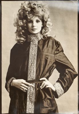 black and white photograph of a woman in a brown dress