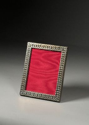 silver and red picture frame on a white surface