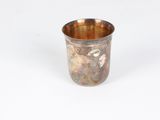 an old silver cup on a white surface with a white background