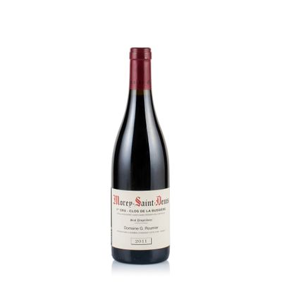 a bottle of red wine sitting on top of a white table