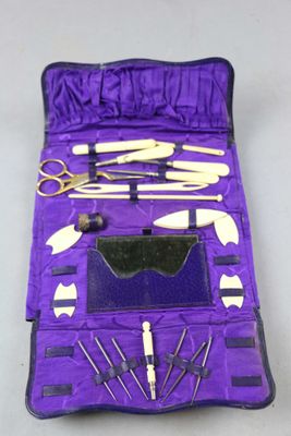 a purple case filled with tools and a pair of scissors