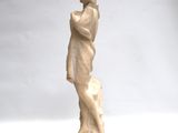 statue of a man standing on a pedestal with his hand on his chin