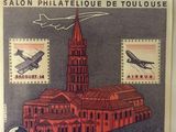 an image of a stamp with a picture of a building and a plane on it