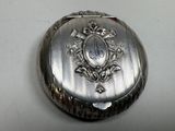 a silver box with a picture on it sitting on a table