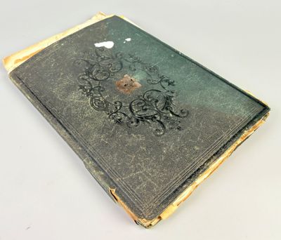 an old book sitting on top of a white table