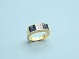 a close up of a gold ring with blue and white diamonds