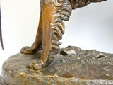 a statue of a dog that is standing on a rock