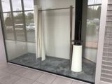 a glass display case with a pole in front of it