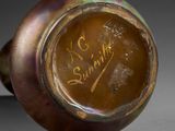 a brown vase with writing on it sitting on a table