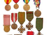 an assortment of medals and medals are displayed on a white surface