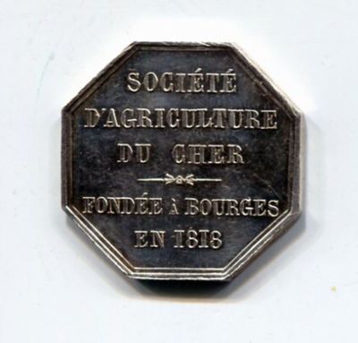une pièce d'argent sur laquelle figure l'image d'un homme