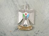 a silver bird with a star on it ' s head