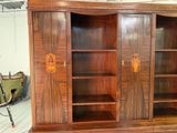 a large wooden cabinet with many shelves in it