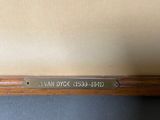 a painting of a wooden frame with a nameplate on it