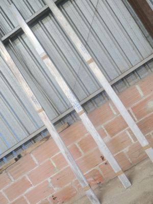 une borne d'incendie rouge posée devant un mur de briques