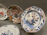 five plates with different designs on them on a table