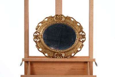 a mirror sitting on top of a wooden shelf