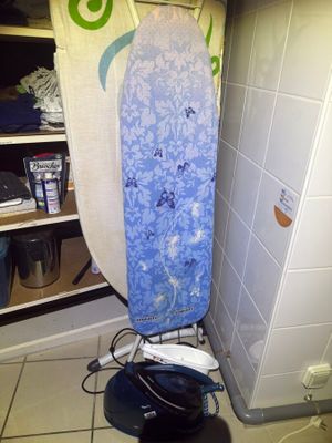 a blue and white surfboard sitting on top of a rack