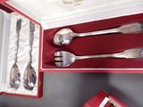 four spoons and two spoons in a red box