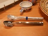 a spoon, spoon and spoon rest on a table