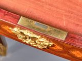 a wooden table with a brass plate on it