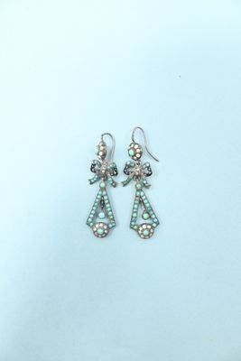 silver and mother of pearl earrings on a white background