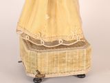 a doll that is sitting on top of a suitcase