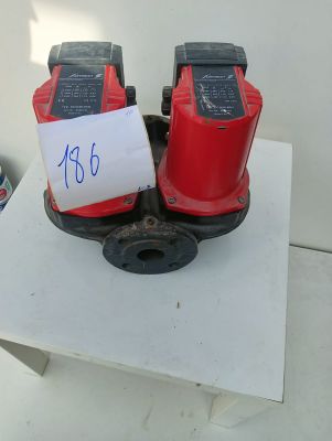 two red fire hydrants sitting on a white table