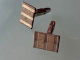 two pieces of wood sitting on top of a table