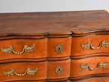 a wooden dresser with many drawers on it in a room