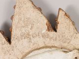 a close up of a piece of bread with a leaf on it