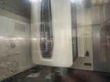 a reflection of a clock in a mirror in a room