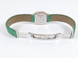 a close up of a green leather bracelet with a silver clasp