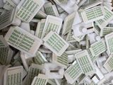 a box full of white plastic pieces with words on them