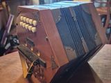 a small accordion sitting on top of a wooden table