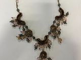 a close up of a necklace on a white surface