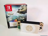 the nintendo switch lite is next to a box with a video game on it