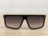 a pair of black sunglasses sitting on top of a wooden table