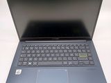 a laptop with a blue keyboard on a white surface