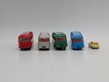 several toy cars are lined up in a row on a white surface