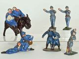 many figurines of men in blue uniforms on a white surface