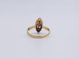 a gold ring with a garnetite stone in the center