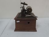 a small wooden box with a sewing machine on it