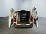 a white van with its doors open in a room