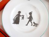 a plate with a picture of a boy and a girl on it